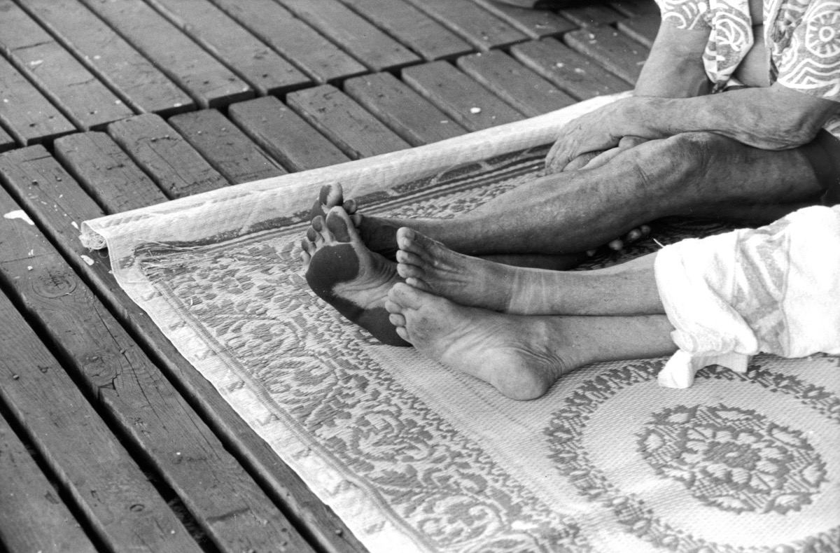 Papeete - Tahiti – Mai 1993. Regardez les pieds de ce polynésien qui vient d'embarquer avec nous sur la « goélette » en partance pour les Iles sous le Vent … Un contraste étonnant avec ceux de sa femme qui l'accompagne dans le voyage. Je ne saurai jamais ce qui a pu les rendre si noirs ... Comme de nombreux îliens, ils vont passer les prochaines 24 heures sur le pont, dans le confort tout relatif de la natte qui leur tient lieu de couchette. Quant à nous, privilégiés, nous avons hérité d'une cabine. Un luxe, même si les vitres des hublots sont cassées, si les cafards partagent notre logis, et si la rouille ronge les parois. C'est aussi cela, le charme du Pacifique.
